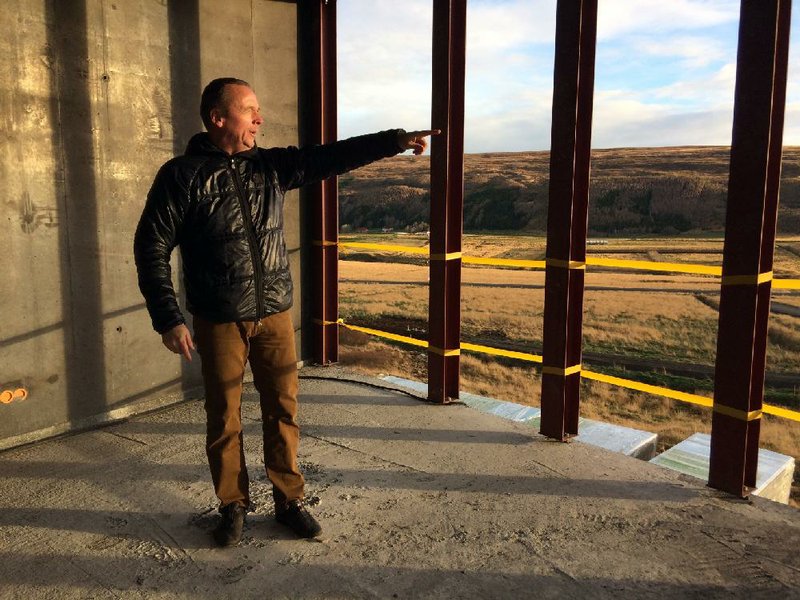 Reinhard Reynisson, managing director of Northeast Iceland Development Agency, looks out at a northern Iceland valley from the first floor of the construction site of Aurora Observatory in Karholl in late October.