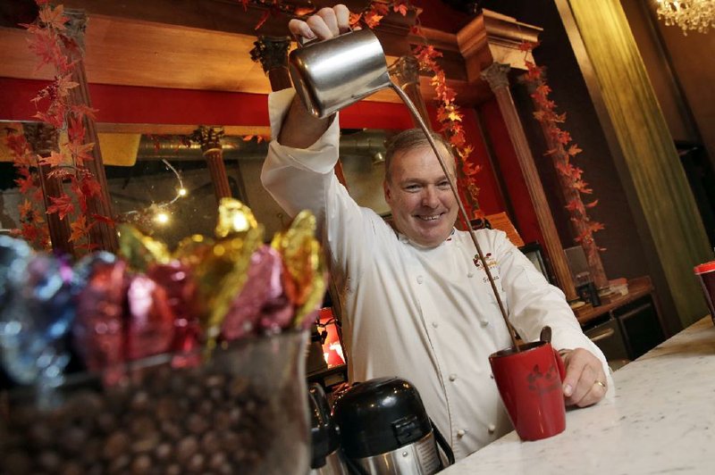 Jacques Torres, who sells his well-known and high-end chocolate and other food at eight locations in New York and online, pours a cup of hot chocolate at his flagship store in New York earlier this month.