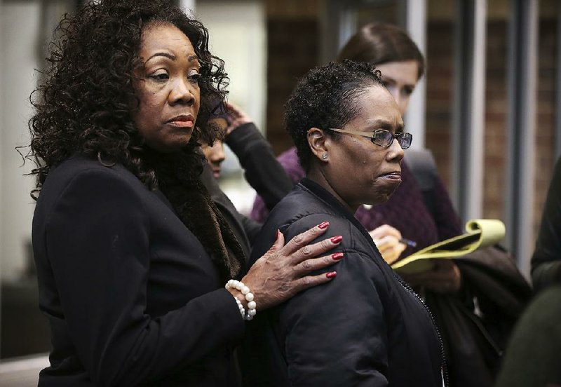 Margaret Brooks (left) consoles Nakia Wilson, a cousin of Philando Castile, after Wilson left the courtroom Friday in St. Paul, Minn., where police officer Jeronimo Yanez had a hearing related to the July killing of Castile.
