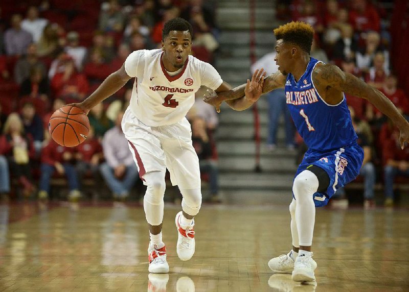 NWA Democrat-Gazette/BEN GOFF @NWABENGOFF
Daryl Macon (4) of Arkansas drives past Erick Neal of UT Arlington on Friday Nov. 18, 2016 during the game in Bud Walton Arena in Fayetteville. 