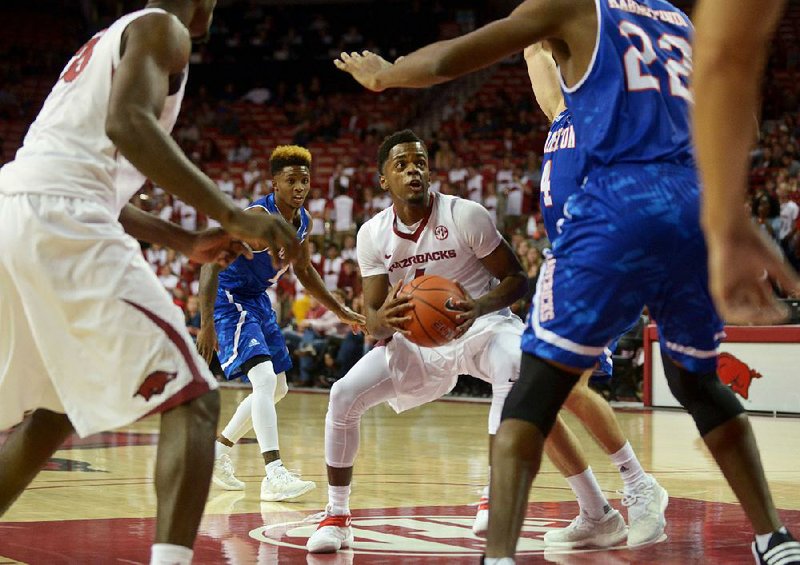 Arkansas guard Daryl Macon (center) looks for a shot between Texas-Arlington defenders in Friday night’s game at Walton Arena in Fayetteville. The Razorbacks rallied from a 17-point first half deficit to beat the Mavericks 71-67.