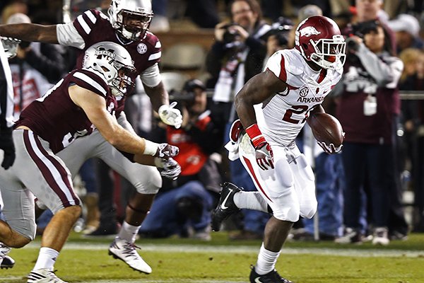 Arkansas running back Rawleigh Williams III (22) runs past Mississippi State defenders on his way to a 72-yard touchdown sprint during the first half of an NCAA college football game against in Starkville, Miss., Saturday, Nov. 19, 2016. (AP Photo/Rogelio V. Solis)

