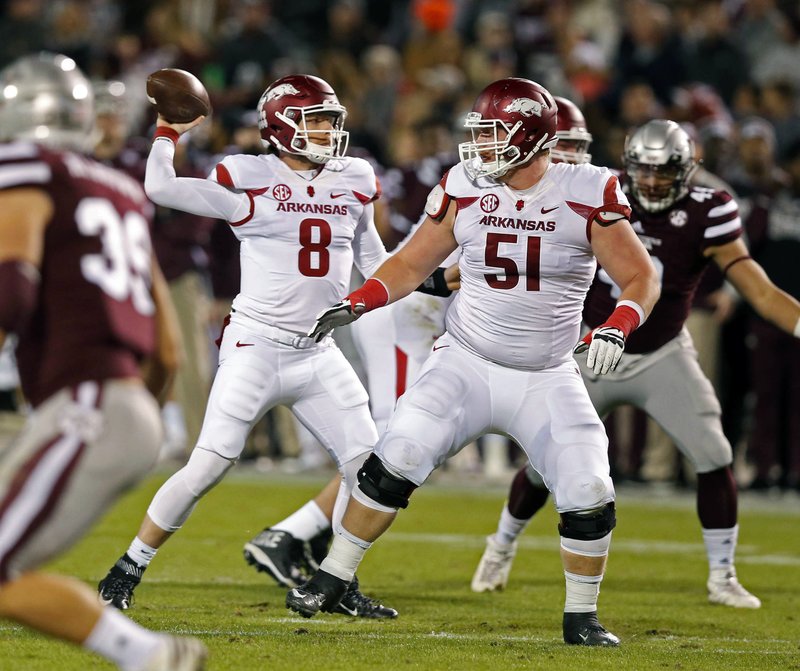 Arkansas quarterback Austin Allen (8) passes against Mississippi State while Arkansas offensive lineman Hjalte Froholdt (51) protects him during the first half of an NCAA college football game against in Starkville, Miss., Saturday, Nov. 19, 2016. (AP Photo/Rogelio V. Solis)
