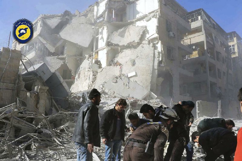 Civil defense workers and Syrian residents inspect the damage to buildings Saturday after airstrikes in the Seif al-Dawleh neighborhood in Aleppo.