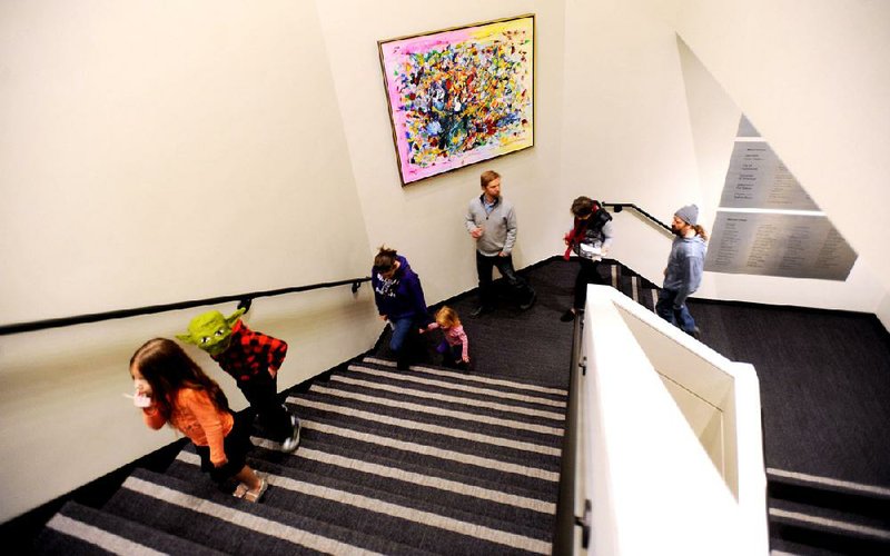 Visitors take in the changes Saturday at the newly reopened Walton Arts Center in Fayetteville. 