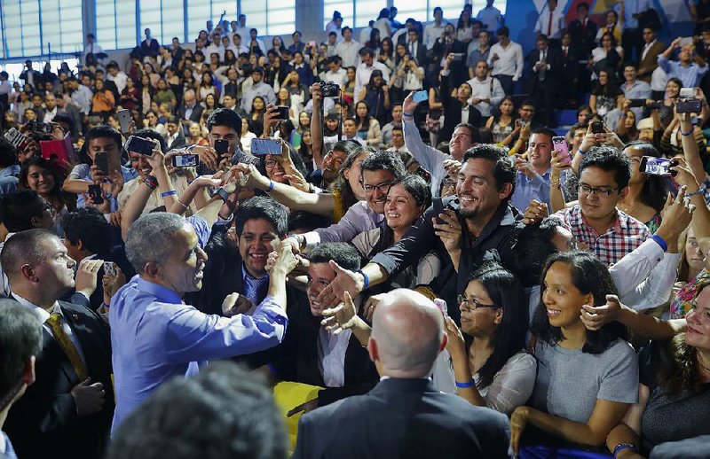 President Barack Obama greets the crowd Saturday after speaking at a town-hall-style meeting with the Young Leaders of the Americas Initiative in Lima, Peru. Obama urged a wait-and-see attitude on President-elect Donald Trump’s trade policies. “Don’t just assume the worst,” he said. “Wait until the administration’s in place.” 
