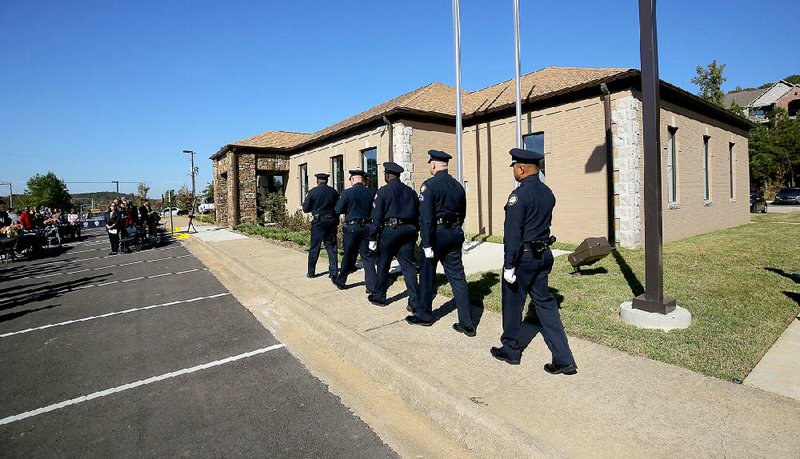 The Little Rock Police Department honor guard marches to flagpoles to present the colors during Tuesday’s grand opening celebration for the long-awaited Josephine Pankey Center in Little Rock.