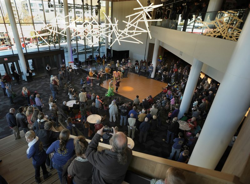 A large crowd gathers Saturday in the lobby to listen to music by Mucca Pazza during an opening celebration at the remodeled and expanded Walton Arts Center in Fayetteville.