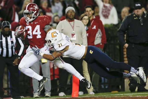 Alabama running back Damien Harris, right, scores a touchdown against Chattanooga defensive back Montrell Pardue during the second half of an NCAA college football game, Saturday, Nov. 19, 2016, in Tuscaloosa, Ala.