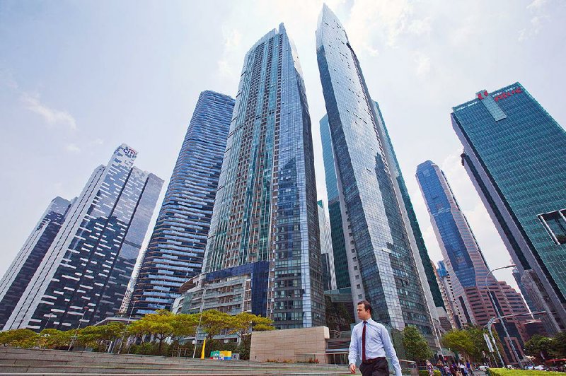 A man strolls in the vicinity of the Marina Bay Financial Centre in Singapore in the spring.