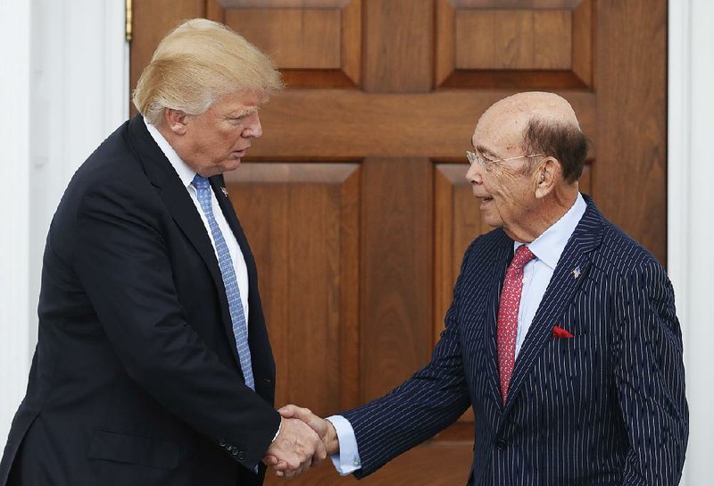 President-elect Donald Trump (left) shakes hands with investor Wilbur Ross after meeting at the clubhouse of Trump National Golf Club Bedminster on Sunday in Bedminster, N.J.
