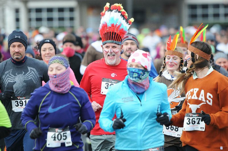 Racers dress in costumes at the annual Turkey Trot 5K held in Rogers to benefit Sheep Dog Impact Assistance.