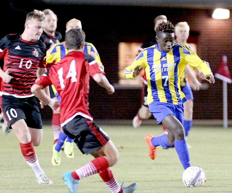 Photo submitted John Brown University midfielder Kelvin Omondi dribbles through the William Carey (Miss.) defense during Saturday&#8217;s opening round of the NAIA National Tournament in Hattiesburg, Miss. William Carey defeated the Golden Eagles 1-0.