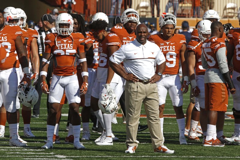 Texas head coach Charlie Strong stands with his players before the start of an NCAA college football game against West Virginia, Saturday, Nov. 12, 2016, in Austin, Texas. (AP Photo/Michael Thomas)
