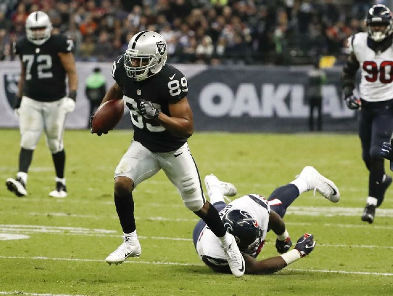 Oakland wide receiver Amari Cooper (left) breaks away from Houston defensive end D.J. Reader in the second half of Monday night’s game in Mexico City. The Raiders overcame a fourth-quarter