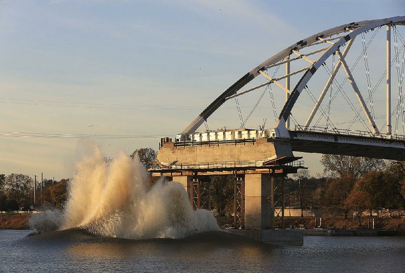 Crews detonate explosives Monday afternoon in an attempt to demolish one of the two remaining footings of the old Broadway Bridge between Little Rock and North Little Rock.