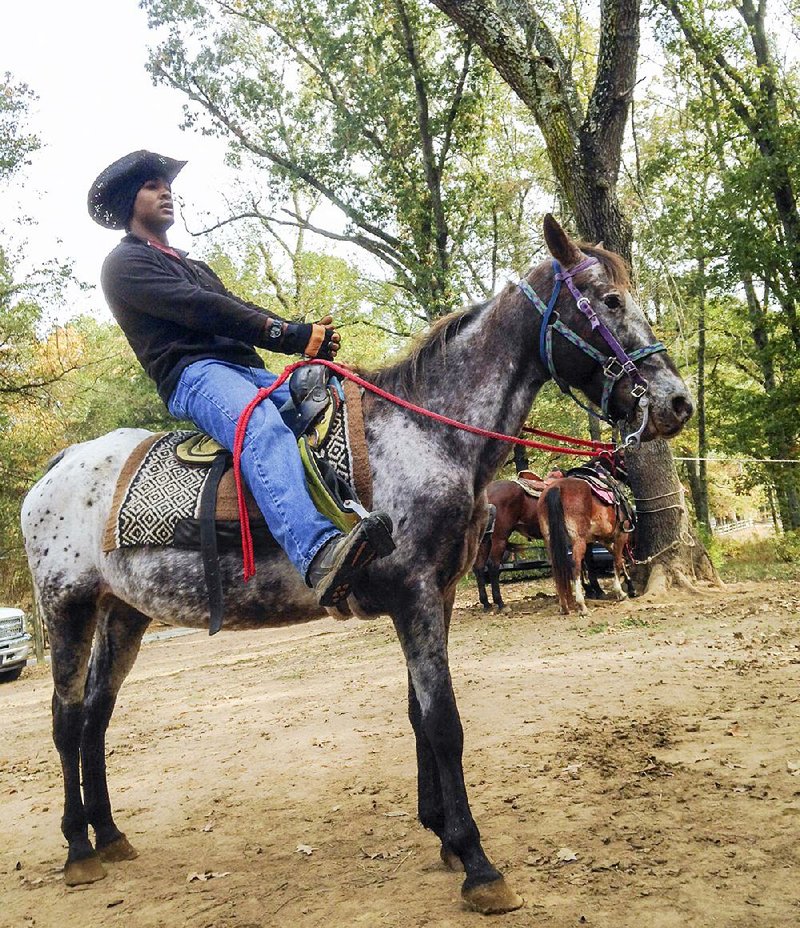 Sanford “Buck” Slater, on his trusty steed Sassy, gives instructions before a Saturday morning ride.