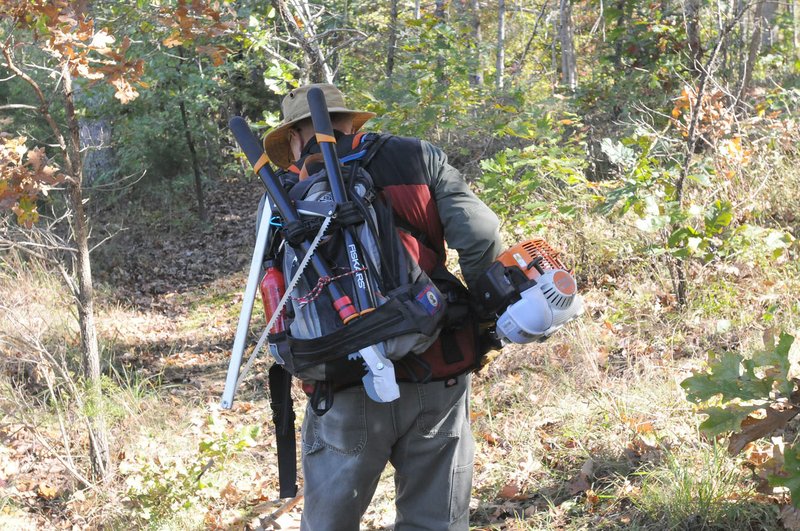 Ken McMullin of Springdale carries tools for trail maintenance. McMullin worked to clear the trail corridor near Sweden Creek Falls.