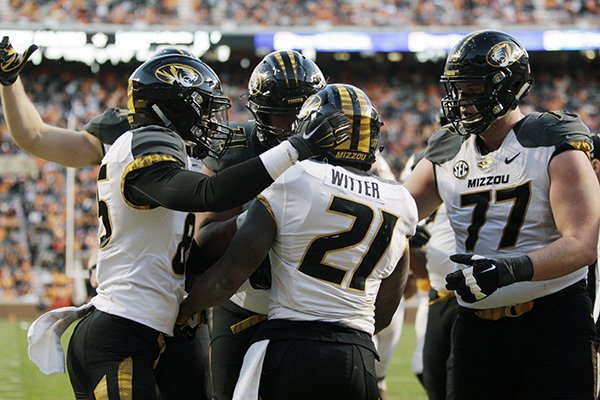 Missouri running back Ish Witter (21) is congratulated by teammates after scoring a touchdown during the first half of an NCAA college football game against Tennessee Saturday, Nov. 19, 2016, in Knoxville, Tenn. (AP Photo/Wade Payne)

