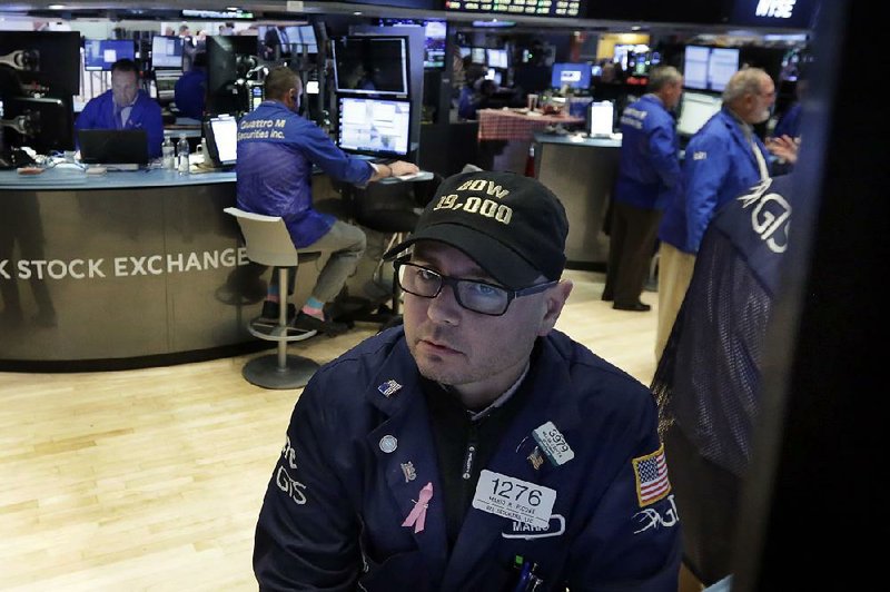 Specialist Mario Picone sports a “Dow 19,000” hat as he works on the floor of the New York Stock Exchange on Tuesday. “The market is a lot more sure of itself now,” one strategist said.