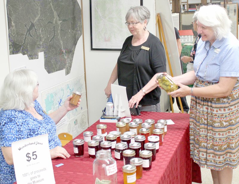 Keith Bryant/The Weekly Vista Jill Werner, left, discusses the jams and fruit butters she has for sale to benefit the museum with GET NAME and Linda Lloyd.