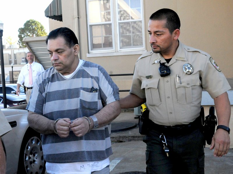 NWA Democrat-Gazette/FLIP PUTTHOFF Mauricio Torres is taken Tuesday from the Benton County courtroom in Bentonville after being sentenced to death for the murder of his six-year-old son in Bella Vista.