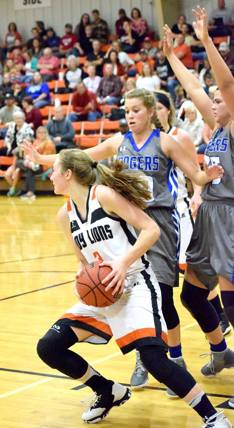 Photo by Mike Eckels Kyrstin Branscum (Gravette 3) tries to find a way around a wall of Rogers&#8217; defenders during the Lady Lion-Lady Mountie basketball game at Gravette Field House Nov. 17. Gravette lost the season opener to Rogers, 69 to 47.