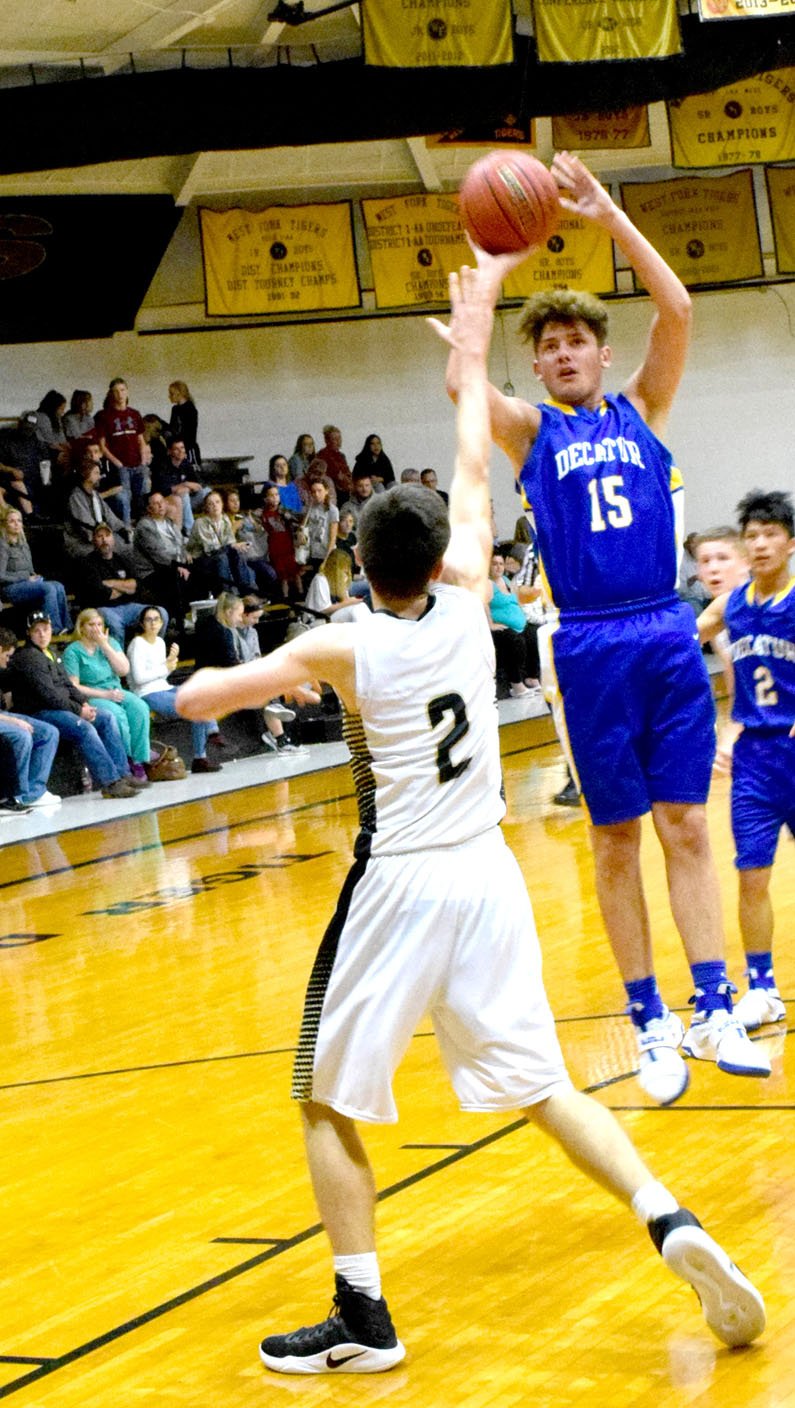 Photo by Mike Eckels Levi Newman (Decatur 15) puts up a jumper at the top of the key during the fourth quarter of the Decatur-West Fork matchup at the Tiger Dome in West Fork Nov. 15.