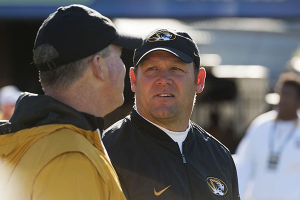 Missouri head coach Barry Odom, right, talks with a fan on the sideline before the start of an NCAA college football game against Vanderbilt, Saturday, Nov. 12, 2016, in Columbia, Mo. (AP Photo/L.G. Patterson)