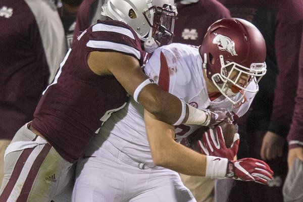 Arkansas tight end Grayson Gunter is tackled during a game against Mississippi State on Saturday, Nov. 19, 2016, in Starkville, Miss.