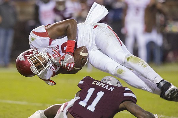 Arkansas tight end Jeremy Sprinkle (83) is tackled by Mississippi State defensive back Kivon Coman (11) after making a reception on Saturday, Nov. 19, 2016, at Davis Wade Stadium in Starkville, Miss., during the third quarter.