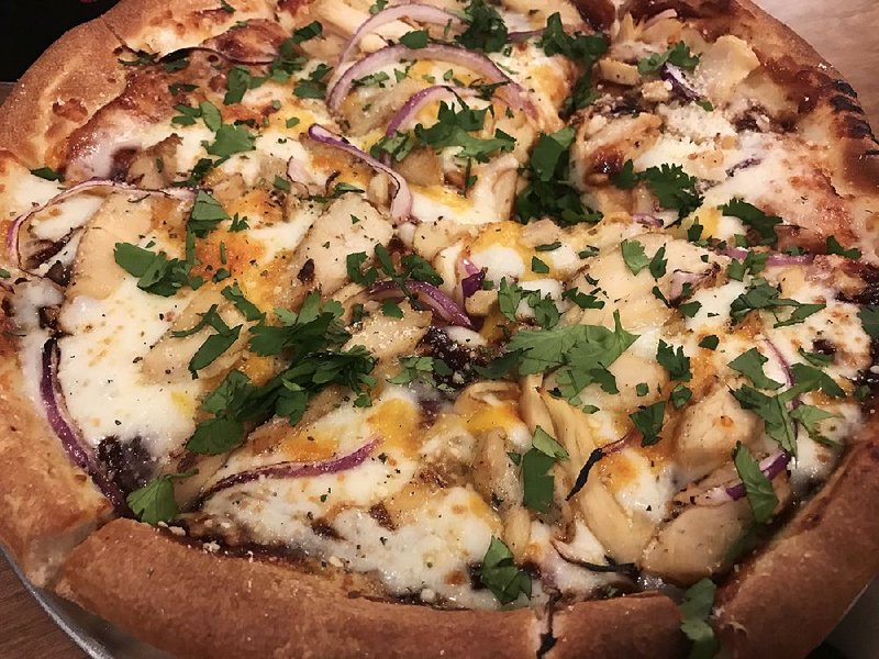 This BBQ Chicken Pizza at Pie Five features grilled chicken, mozzarella, cheddar, red onions and a sprinkle of cilantro with a barbecue-sauce base. 
