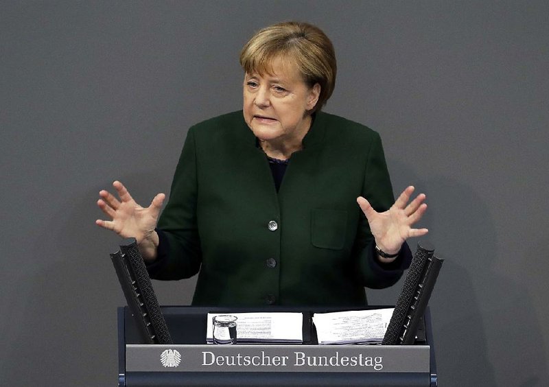 German Chancellor Angela Merkel addresses German lawmakers on Wednesday. While not mentioning President-elect Donald Trump by name, Merkel made plain her unease about his stand on trade agreements.