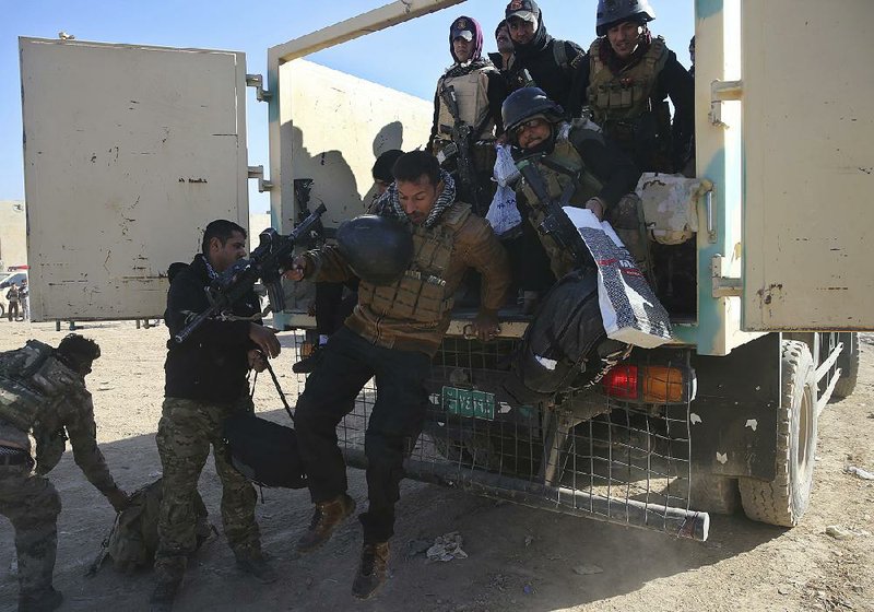 Iraqi special forces soldiers jump from a military truck as they arrive to relieve soldiers returning from the battlefield, in the Al-Samah front line neighborhood, in Mosul, Iraq, on Wednesday. An airstrike by the U.S.-led coalition on Wednesday “disabled” the fourth bridge on the Tigris River in Mosul, leaving the northern Iraqi city with a single functioning bridge, according to the Iraqi military and the Islamic State’s media arm.