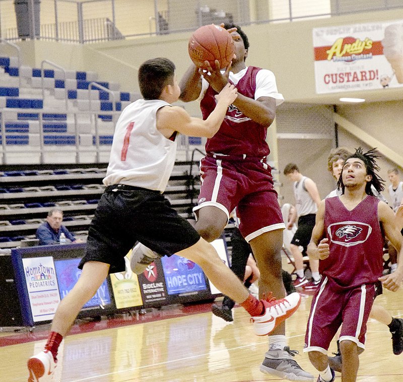 Photo by Rick Peck McDonald County guard Sergio Dozal tries to stop a Joplin fast break, but instead gets whistled for a foul during a scrimmage held Nov. 18 at Joplin High School.