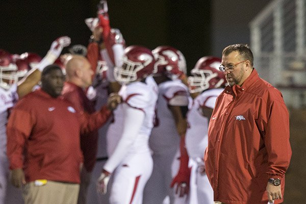 Arkansas coach Bret Bielema watches as players prepare to take the field for warmups prior to a game against Mississippi State on Saturday, Nov. 19, 2016, in Starkville, Miss. 