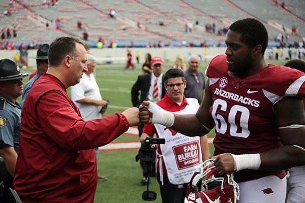Arkansas coach Bret Bielema, left, congratulates offensive lineman Brian Wallace as he leaves the field following a game against Alcorn State on Saturday, Oct. 1, 2016, in Little Rock. 