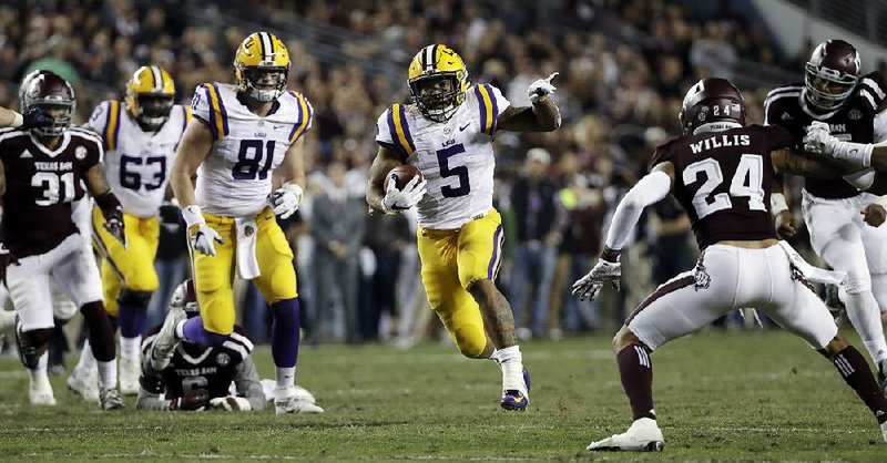 LSU running back Derrius Guice runs through the Texas A&M defense during the second half of Thursday’s game. Guice ran 37 times for 285 yards and 4 touchdowns as the Tigers pulled away to beat the Aggies 54-39. 
