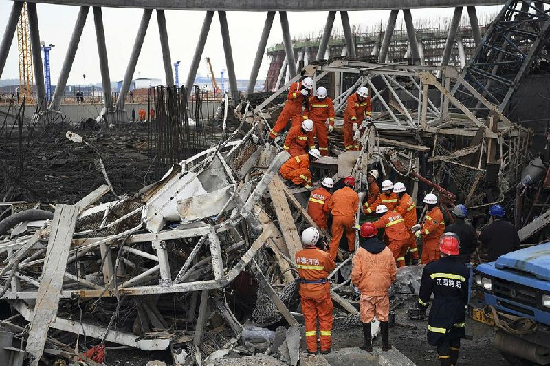 Rescue workers look for survivors after a work platform collapsed Thursday at the Fengcheng power plant in eastern China’s Jiangxi province.