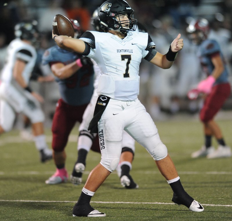 Canaan Ross of Bentonville passes Friday, Oct. 14, 2016, through the Springdale defense during the first half of play at Jarrell Williams Bulldog Stadium in Springdale. 