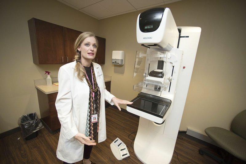 NWA Democrat-Gazette/J.T. WAMPLER Dr. Britton B. Lott, breast imaging physician at The Breast Center, shows off a new imaging machine Tuesday. The center has moved back to its Fayetteville clinic and expanded from 10,000 square feet to 12,000 square feet to create two separate clinics, one for screening mammograms and another for diagnostic breast imaging.