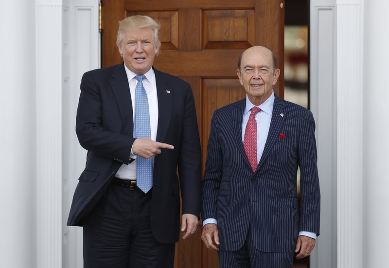 In this Sunday, Nov. 20, 2016, file photo, President-elect Donald Trump, left, stands with investor Wilbur Ross after meeting at the Trump National Golf Club Bedminster clubhouse in Bedminster, N.J. 