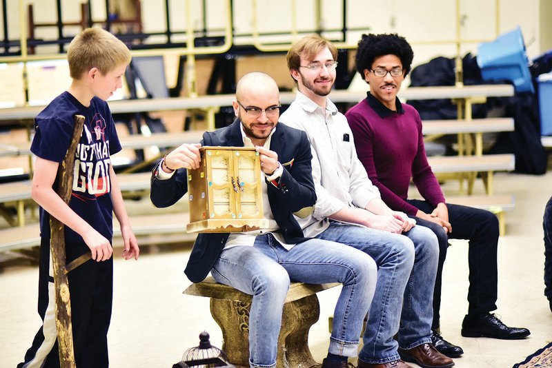 Kaspar, played by Jorge Martinez, second from left, shows his magical box to Amahl, played by Todd Butler, 
left, in this rehearsal scene of Amahl and the Night Visitors. Kaspar, who is one of the Three Wise Men, tells Amahl: “This is my box, this is my box. I never travel without my box.” Among the items in his box are magic stones, beads and licorice. Looking on are the other two Wise Men — Clay Sanders, third from the left, who plays Melchior, and Ron Jensen-McDaniel, right, who plays Balthazar.