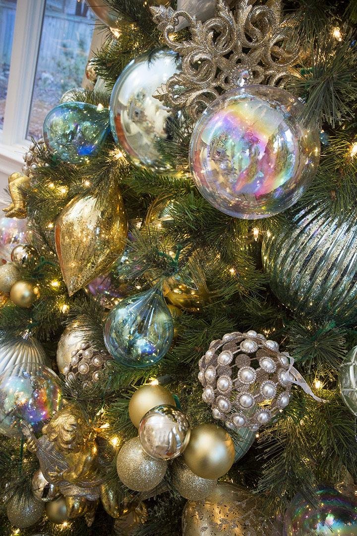 Decorating for Christmas on a budget, but want big-money elegance? Try combining bunches of smaller, less expensive Christmas ornaments with larger, more upscale ones. Shown: A tree decorated by Shayla Copas of Little Rock’s Shayla Copas Interiors.