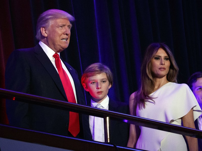 The Associated Press LONG-DISTANCE FIRST LADY: President-elect Donald Trump, left, arrives to speak at an election night rally with his son Barron and wife Melania on Nov. 9 in New York. Breaking with tradition, the president-elect will move into the White House after the inauguration while his wife Melania and 10-year-old son Barron plan to remain in New York City until at least the end of the school year.