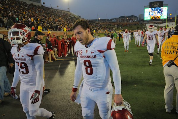 Arkansas' Austin Allen walks off the field after a disappointing loss to Missouri Friday in Columbia, Mo.