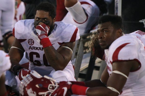 Arkansas players including Brian Wallace, (60) and Jeremy Sprinkle, right, react on the sidelines after a disappointing loss to Missouri Friday in Columbia, Mo.
