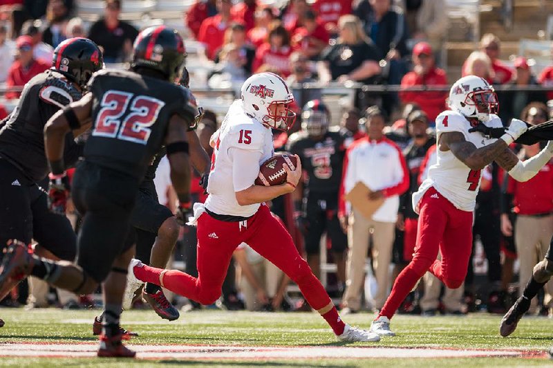 Arkansas State quarterback Justice Hansen scrambles for yardage in Saturday’s game against Louisiana-Lafayette. Hansen led the team with 47 yards rushing, and he also passed for 393 yards for the Red Wolves, whose 24-19 loss was their fi rst of the season in Sun Belt Conference play.