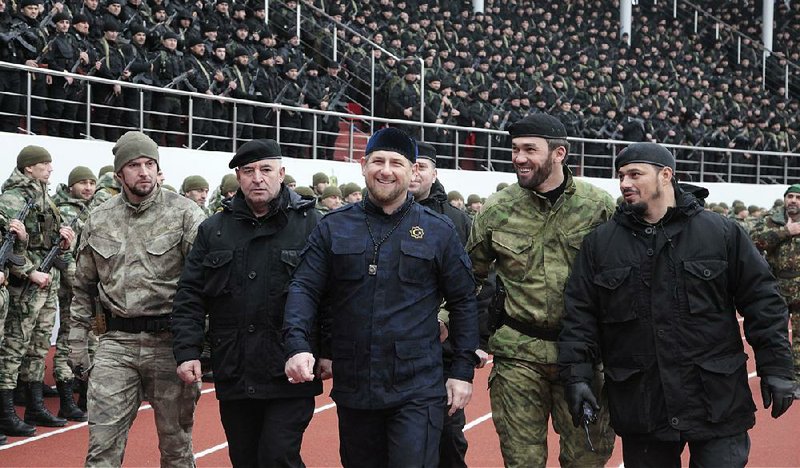 Ramzan Kadyrov (center) inspects Chechen special forces with top commanders in December 2014 during a rally at a stadium in Chechnya’s capital, Grozny. Disputing his image as a frightening killer, Kadyrov contends that “on the contrary, people run to me. They hug me.”