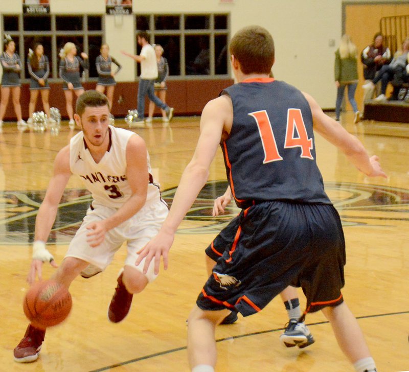 Graham Thomas/Siloam Sunday Siloam Springs senior Josh Heinrichs drives to the basket as Heritage&#8217;s Bryce Breedlove defends during Monday&#8217;s game at Panther Activity Center. Heritage defeated the Panthers 50-34.